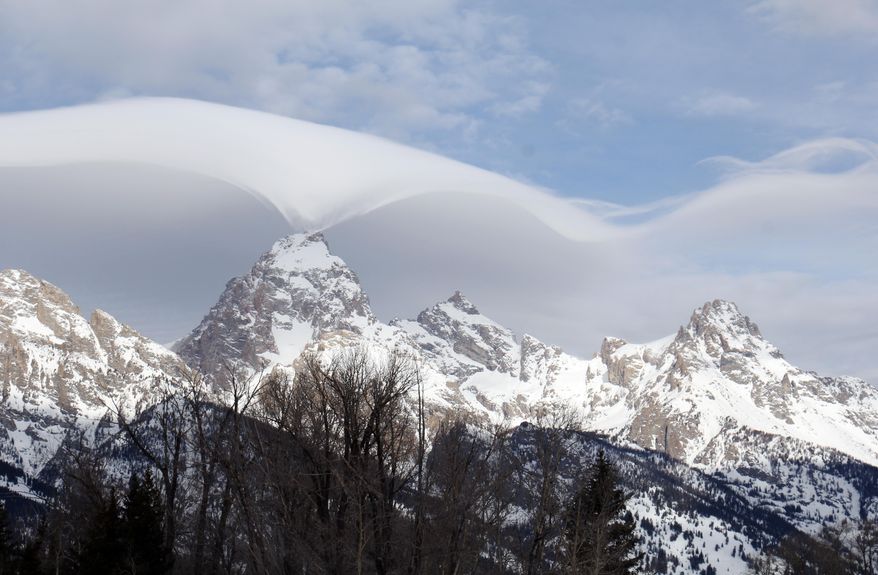 This photo taken Thursday, Feb. 12, 2015, and provided by the Grand Teton National Park, shows an unusual cloud formation across the summit of the Grand Teton in this view from the park's headquarters campus at Moose, Wyo. (AP Photo/Grand Teton National Park, Jackie Skaggs) ** FILE **