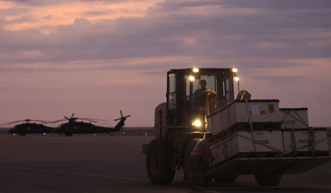U.S. army soldiers load equipments onto an aircraft, not seen, as they prepare to make the journey home at al-Asad airbase west of Baghdad, Iraq, on Nov. 1 , 2011. (AP Photo/Khalid Mohammed) **FILE** 
