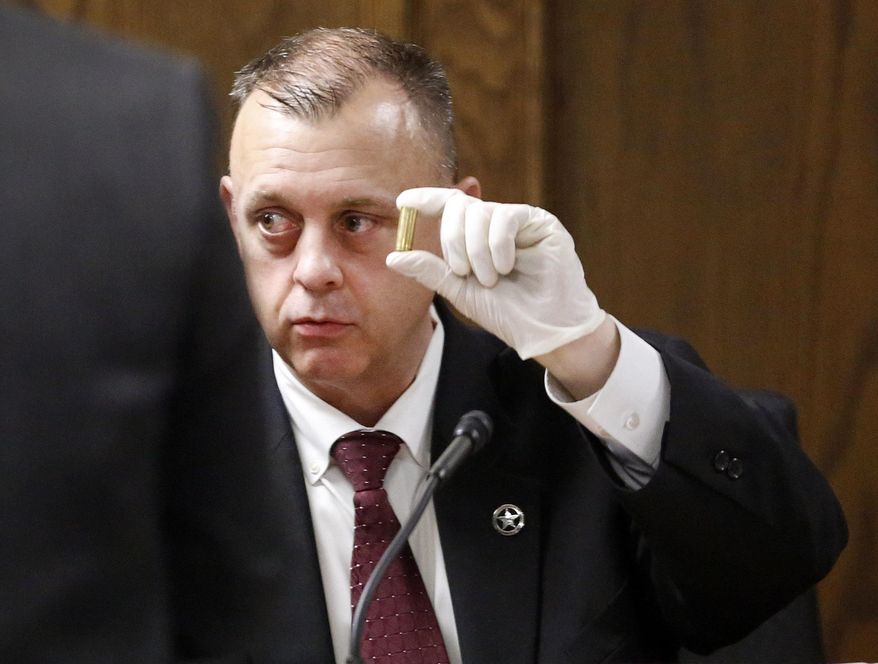 Texas Ranger Michael Adcock holds a shell casing from the crime scene as he testifies during former Marine Cpl. Eddie Ray Routh&#x27;s capital murder trial at the Erath County Donald R. Jones Justice Center in Stephenville, Texas, Feb. 12, 2015. Routh, 27, of Lancaster, Texas, is charged with the 2013 deaths of former Navy SEAL Chris Kyle and his friend Chad Littlefield at a shooting range near Glen Rose, Texas. (AP Photo/The Dallas Morning News, Tom Fox, Pool)