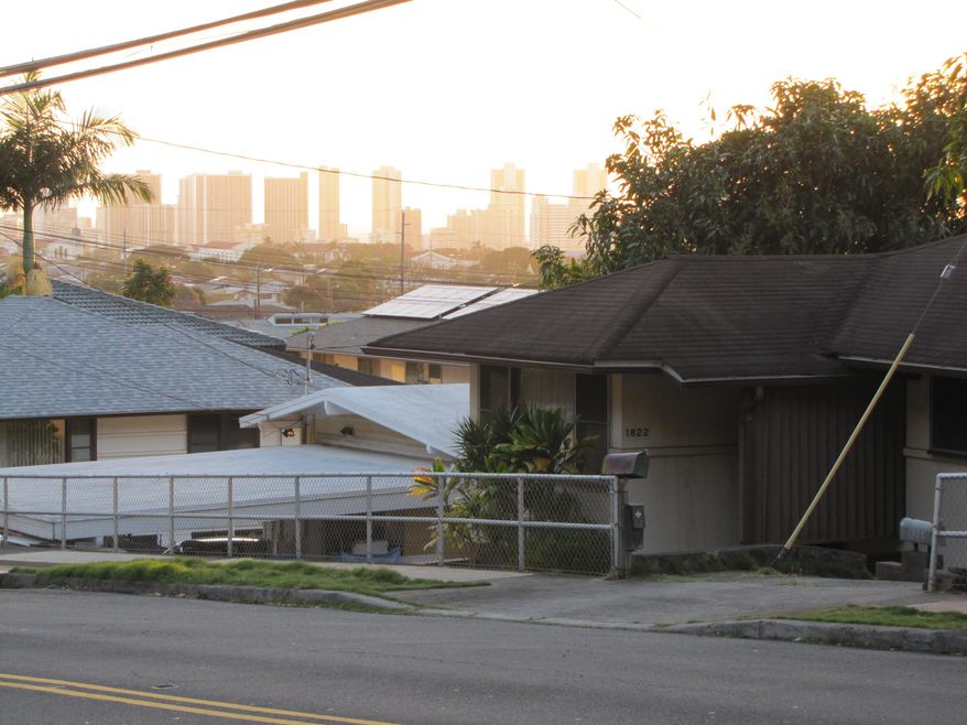 Rep. Calvin Say’s Palolo Valley home, on 10th Ave. in Honolulu, is seen on Tuesday, Feb. 10, 2015. This Palolo Valley home is at the center of a residency dispute that could unseat the state’s longest-serving representative. This marks the first time such questions have come before a House committee. It's also the first time in state history that a special legislative panel has come together to determine whether a state representative was qualified to hold office. (AP Photo/By Cathy Bussewitz)