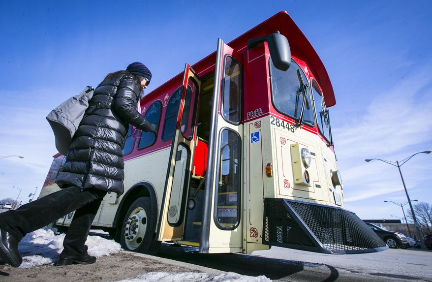 In this photo taken Thursday, Feb. 12, 2014, Des Moines' free shuttle service D-Line trolley picks up passengers at the Capitol Complex on its route in Des Moines, Iowa. The future of the popular downtown shuttle is in doubt after an organization decided to stop contributing to the program. (AP Photo/The Des Moines Register, Rodney White) MAGS OUT, TV OUT, NO SALES, MANDATORY CREDIT