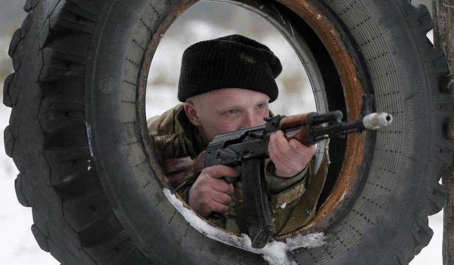 A newly mobilized Ukrainian soldier shows his skills during military drills in base Desna 100km north from Kiev, Ukraine, Friday, Feb. 13, 2015. Fierce fighting surged in East Ukraine as Russian-backed separatists mounted a major and sustained new push Friday to capture a strategic railway hub ahead of a weekend cease-fire deadline. (AP Photo/Efrem Lukatsky)