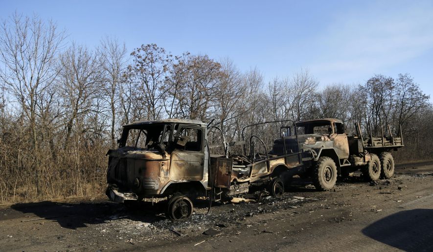 In this Feb. 13, 2015, photo, destroyed Ukrainian army vehicles lie on the side of the road towards Debaltseve near the town of Artemivsk, Ukraine. The Cold War didn’t end. It just took on a 24-year pause. The East-West showdown over Ukraine makes that clear. As the non-Russian republics broke free in the Soviet collapse and Eastern European Soviet satellite countries snapped the chains of Moscow’s dominion, common wisdom held that the Cold War was over. (AP Photo/Petr David Josek)