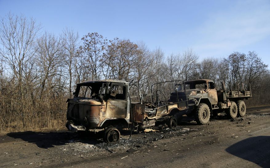 In this Feb. 13, 2015, photo, destroyed Ukrainian army vehicles lie on the side of the road towards Debaltseve near the town of Artemivsk, Ukraine. The Cold War didn’t end. It just took on a 24-year pause. The East-West showdown over Ukraine makes that clear. As the non-Russian republics broke free in the Soviet collapse and Eastern European Soviet satellite countries snapped the chains of Moscow’s dominion, common wisdom held that the Cold War was over. (AP Photo/Petr David Josek)