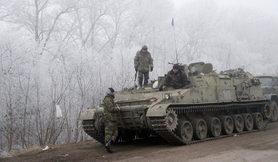 Ukrainian government soldiers were resting Sunday between the towns of Debaltseve and Artemivsk during a reprieve from a conflict that has claimed more than 5,300 lives. (Associated Press)