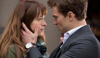 In this image released by Universal Pictures and Focus Features, Dakota Johnson, left, and Jamie Dornan appear in a scene from the film, &amp;quot;Fifty Shades of Grey.&amp;quot;  (AP Photo/Universal Pictures and Focus Features)
