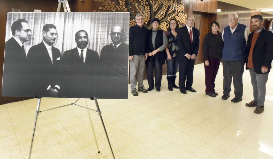 In this Feb. 5, 2015 photo, a group gathers at Congregation Mishkan Israel in Hamden, Conn., to remember when Dr. Martin Luther King, Jr., visited the temple to preach on Oct. 20, 1961. King is shown second from right in the 1961 photo with leaders of the temple at that time. (AP Photo/New Haven Register, Peter Hvizdak)
