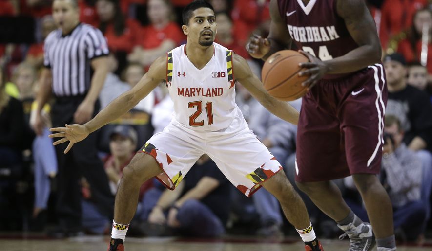 Maryland guard Varun Ram (21) guards Fordham guard Bryan Smith during an NCAA college basketball game, Thursday, Nov. 20, 2014, in College Park, Md. (AP Photo/Patrick Semansky)