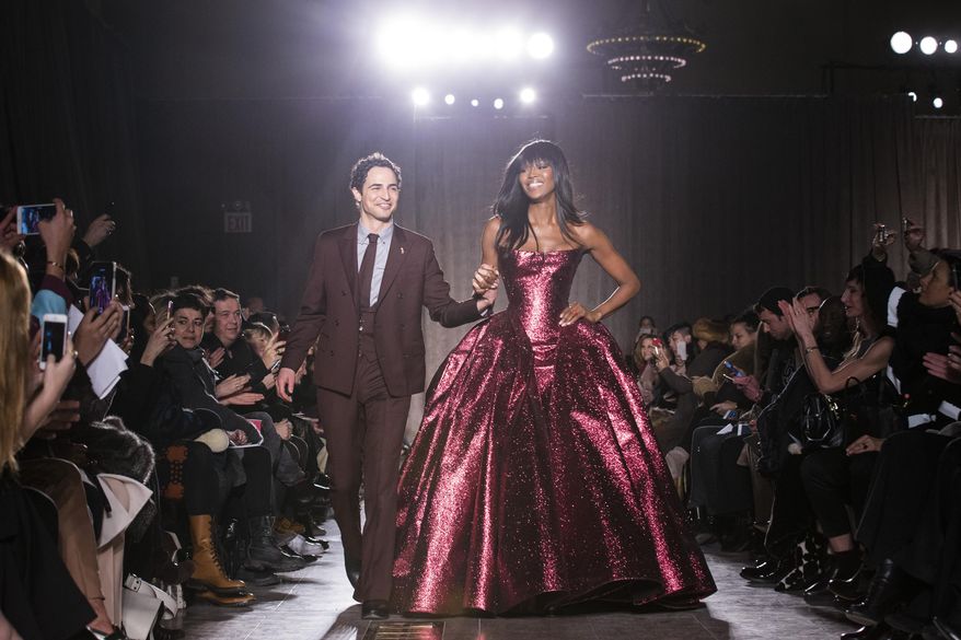 Designer Zac Posen and model Naomi Campbell greet the crowd after his Fall 2015 collection is modeled during Fashion Week, Monday, Feb. 16, 2015, in New York. (AP Photo/John Minchillo)