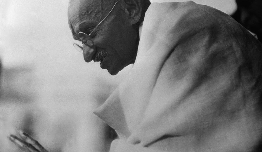 Mahatma Gandhi shown acknowledging cheers from the crowds which greeted him on his arrival after being released from prison in Poona, Jan. 20, 1931, Bombay, India. He was confined eight months. (AP Photo)