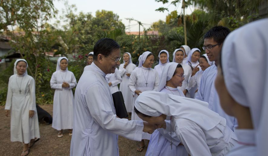 A nun kisses the ecclesiastical ring of newly appointed Cardinal Charles Maung Bo, at St. Paul’s Missionary school in the suburbs of Yangon, Myanmar, Monday, Jan. 5, 2015. Church colleagues on Monday proudly welcomed home Archbishop Charles Maung Bo, a day after his appointment by Pope Francis as Myanmar's first Roman Catholic cardinal. Bo’s appointment comes as Myanmar grapples with major problems of religious intolerance, particularly by members of the Buddhist majority toward Muslims of the Rohingya ethnic minority. (AP Photo/Gemunu Amarasinghe)