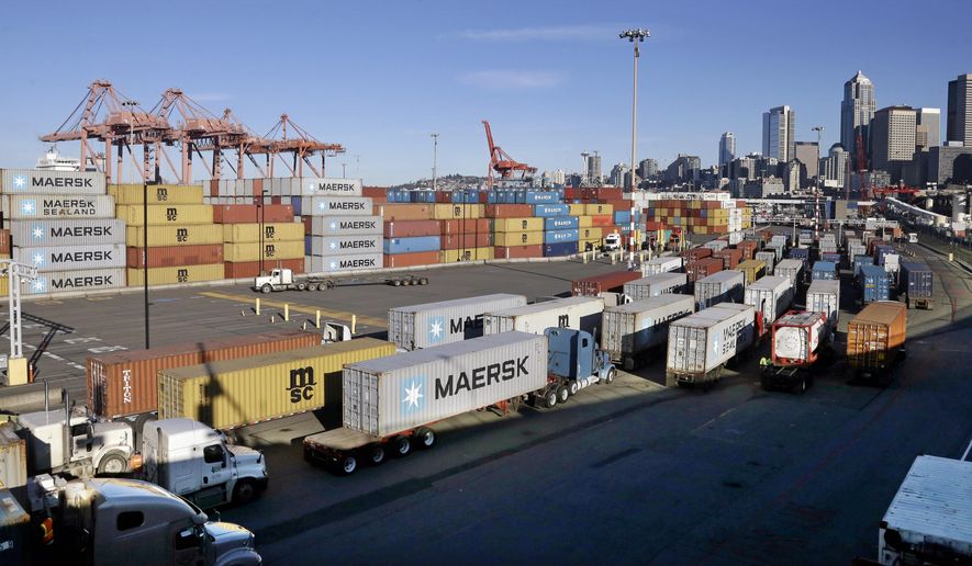 Loaded container trucks line-up at a gate at the Port of Seattle Tuesday, Feb. 17, 2015, in Seattle. Seaports in the U.S. West Coast that were all but shut over the weekend because of a contract dispute are reopening as the nation's top labor official tries to solve a stalemate between dockworkers and their employers that already has disrupted billions of dollars in U.S. international trade. U.S. Labor Secretary Thomas Perez plans to meet Tuesday in San Francisco with negotiators for both the dockworkers' union and the maritime association, which represents shipping lines that carry cargo and port terminal operators that handle it once the ships dock. (AP Photo/Elaine Thompson)