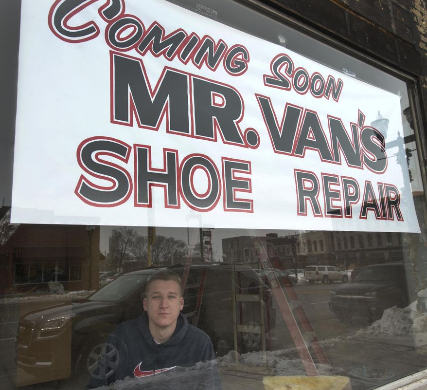Garrett Williams, 21, sits in the window of the new Mr. Van's Shoe Repair in Old Town Saginaw, Feb. 11, 2015. The original Mr Van's in Saginaw Township's Green Acres Plaza closed last year and Williams purchased the business. Williams and a construction crew are renovating the building on Court exposing and cleaning the original floor and brick walls with plans to open on April 1. (AP Photo/The Saginaw News, Jeff Schrier) ALL LOCAL TELEVISION OUT; LOCAL TELEVISION INTERNET OUT