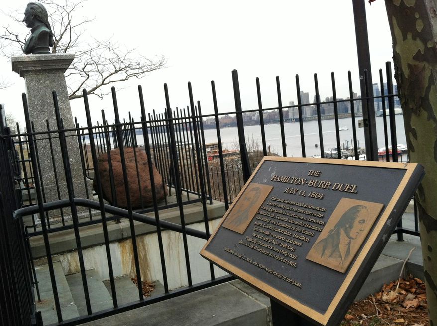 This Jan. 20, 2015 photo shows Hamilton Park in Weehawken, N.J., on the Hudson River across from Manhattan. The plaque and bust of Alexander Hamilton mark the dueling grounds where Hamilton was fatally shot by Aaron Burr in 1804. A new musical, "Hamilton," has just opened off-Broadway in New York, using hip-hop and history to tell the story of Hamilton's rise from immigrant orphan to George Washington's right-hand man. (AP Photo/Beth J. Harpaz)