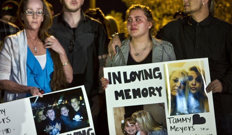 In this Tuesday, Feb. 17, 2015, photo, people participate in a candlelight vigil for Tammy Meyers, who was taken off life support on Saturday after a shooting in Las Vegas. What police first described as a road rage-inspired shooting of an innocent mother of four has morphed into a more complex scenario, prompting a backlash Wednesday against the Las Vegas family and the way the case is being handled. (AP Photo/Las Vegas Sun, L.E. Baskow) LAS VEGAS REVIEW-JOURNAL OUT