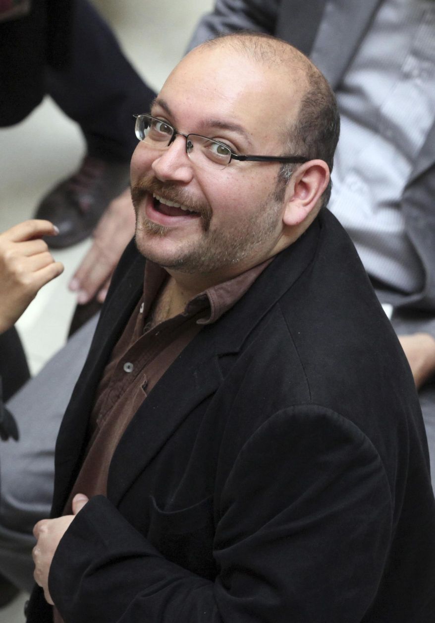 FILE - In this photo April 11, 2013 file photo, Jason Rezaian, an Iranian-American correspondent for the Washington Post, smiles as he attends a presidential campaign of President Hassan Rouhani in Tehran, Iran. The brother of the detained Washington Post correspondent said Wednesday, Feb. 18, 2015 that a new lawyer chosen by the family has been unable to meet with the Iranian-American journalist to complete formalities that would allow him to represent him.(AP Photo/Vahid Salemi, File)