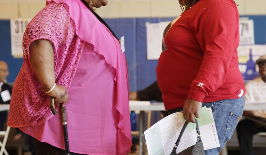 FILE - In this Tuesday, June 26, 2012 file photo, two overweight women speak to each other in New York. There may be more fruit, vegetables and healthy options available than ever before, but the world is mostly hungry for junk food, according to a study of eating habits in nearly 190 countries that was released on Wednesday, Feb. 18, 2015. (AP Photo/Mark Lennihan, File)