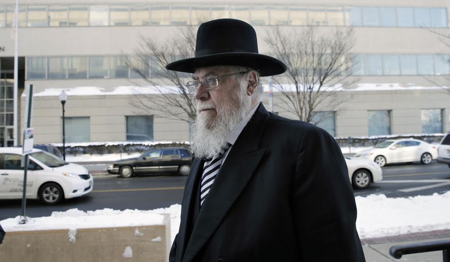 Rabbi Mendel Epstein, right, arrives for his trial at federal court in Trenton, N.J. on Wednesday, Feb. 18, 2015. Prosecutors say Epstein employed a kidnap team to force unwilling Jewish husbands to divorce their wives. (AP Photo/Mel Evans)