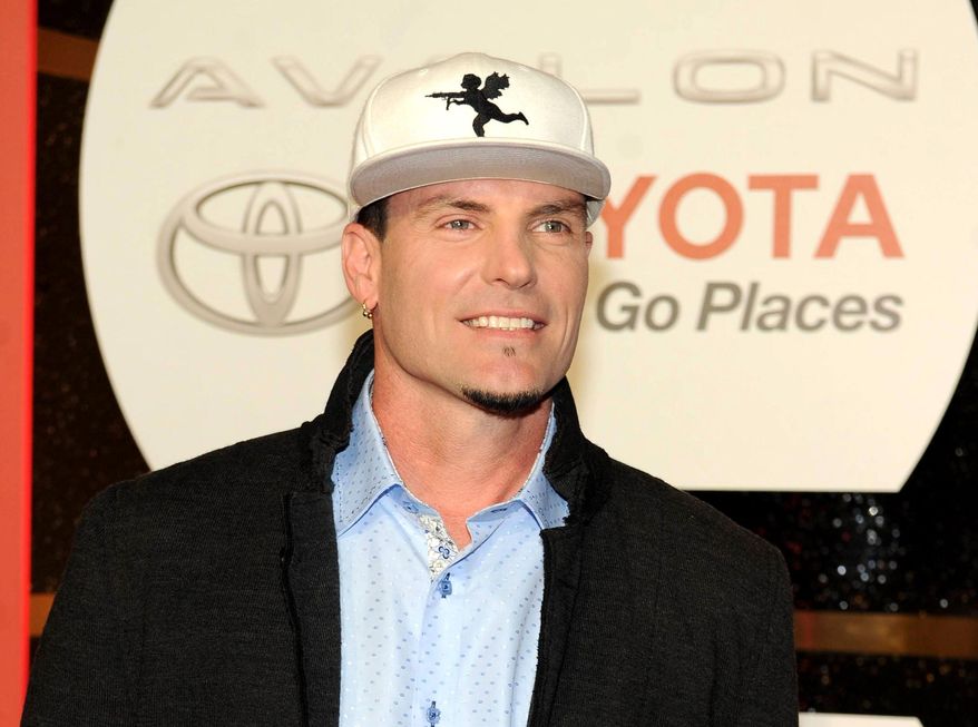 FILE - In this Nov. 8, 2013 file photo, recording Artist Vanilla Ice arrives at the 2013 Soul Train Awards at the Orleans Arena in Las Vegas. Police in the Palm Beach County town of Lantana, Fla., say the recording artist and home-improvement-show host has been charged with breaking into and stealing from an abandoned home that is in foreclosure. They said in a news release that some of the items stolen were found at his property. Vanilla Ice, whose real name is Robert Van Winkle, rose to fame following the 1990 release of the hit song "Ice Ice Baby." In recent years, he has hosted "The Vanilla Ice Project" on DIY Network. (Photo by Frank Micelotta/Invision/AP, File)