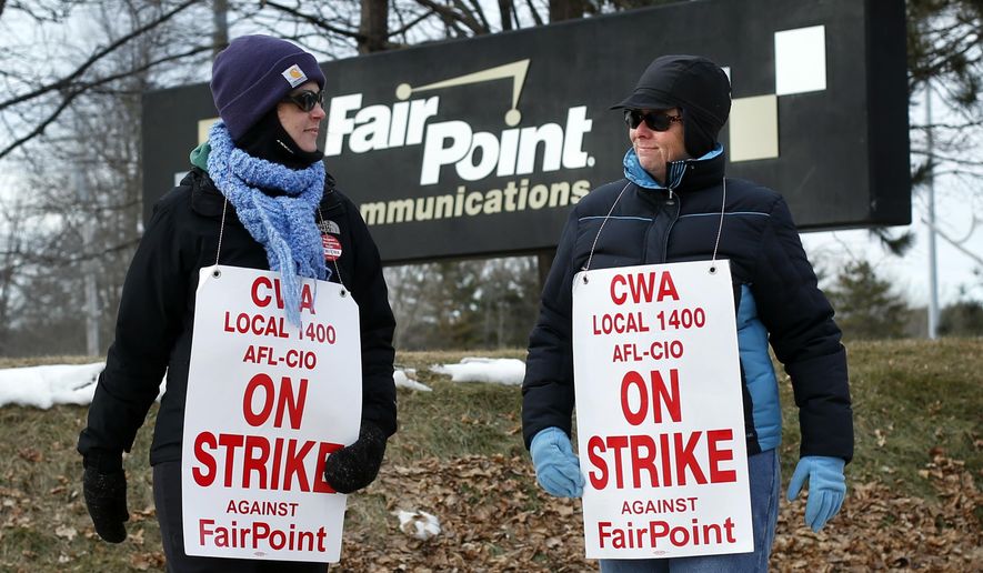 FILE - In this Jan. 23, 2015 file photo, Fairpoint employees Amber Lyman, left, and Julie Sawtelle picket outside the Fairpoint offices in Portland, Maine. Northern New England’s primary landline provider, FairPoint Communications, and two unions representing more than 1,700 workers announced Thursday, Feb. 19, 2015 that they had reached a tentative agreement to end the four-month strike. (AP Photo/Robert F. Bukaty, File)