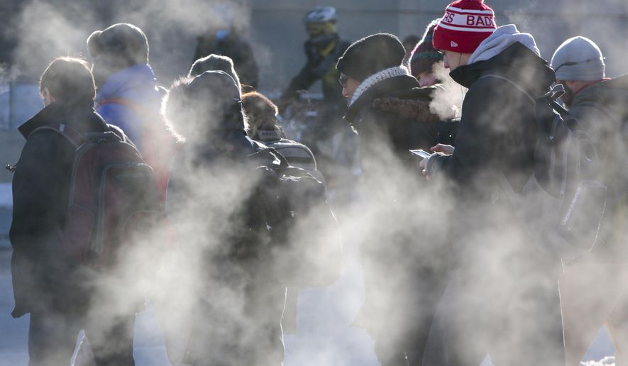 Students cross the intersection of University Avenue and North Park Street in cold weather on the University of Wisconsin-Madison campus in Madison, Wis., Thursday, Feb. 19, 2015. (AP Photo/Wisconsin State Journal, M.P. King)