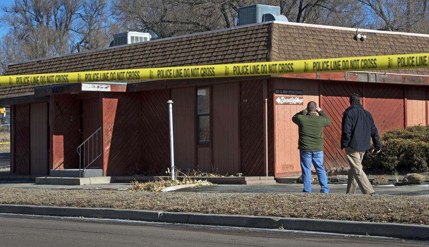 Colorado Springs, Colo., police officers investigate the scene of a Jan. 6, 2015, explosion at a building in Colorado Springs that houses a barber shop and the Colorado Springs chapter of the NAACP. (Associated Press/The Colorado Springs Gazette, Christian Murdock) **FILE**