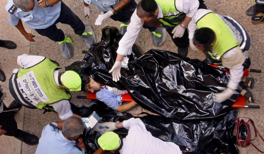 FILE - In this July 31, 2002 file photo. police and volunteers examine the body of one of the victims of an explosion at Hebrew University of Jerusalem. Palestinian officials are nervously watching a landmark terrorism trial in the U.S brought by victims of Palestinian suicide bombings and shootings aimed at civilians, fearing a negative verdict could hurt their international image at a time when they are preparing to press war crimes charges against Israel. (AP Photo/John McConnico, File)
