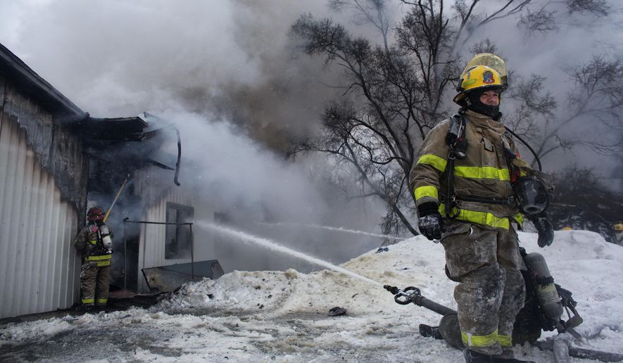 Kalamazoo Public Safety officers respond to a fire at Hollywood Nights in Kalamazoo, Mich. on Wednesday Feb. 18, 2015. A 41-year-old Kalamazoo man is accused of burning down the adult entertainment store. The man is currently being held in the Kalamazoo County Jail and is expected to be charged Friday, Feb. 20, 2015. No one was injured in the blaze. (AP Photo/Kalamazoo Gazette-MLive Media Group, Christian Randolph) ALL LOCAL TELEVISION OUT; LOCAL TELEVISION INTERNET OUT