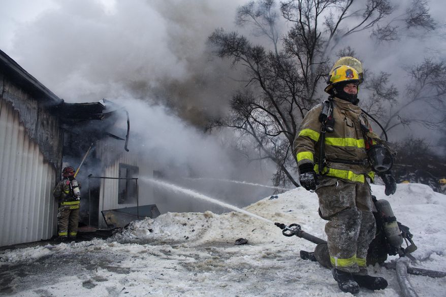 Kalamazoo Public Safety officers respond to a fire at Hollywood Nights in Kalamazoo, Mich. on Wednesday Feb. 18, 2015. A 41-year-old Kalamazoo man is accused of burning down the adult entertainment store. The man is currently being held in the Kalamazoo County Jail and is expected to be charged Friday, Feb. 20, 2015. No one was injured in the blaze. (AP Photo/Kalamazoo Gazette-MLive Media Group, Christian Randolph) ALL LOCAL TELEVISION OUT; LOCAL TELEVISION INTERNET OUT