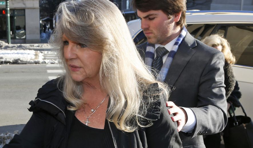 Former first lady Maureen McDonnell, left, arrives at federal court with her son Bobby for her sentencing on corruption charges in Richmond, Va., Friday, Feb. 20, 2015. Federal prosecutors have recommended an 18-month prison term, six months less than former Gov. Bob McDonnell received when he was convicted on 11 counts last month. (AP Photo/Steve Helber)