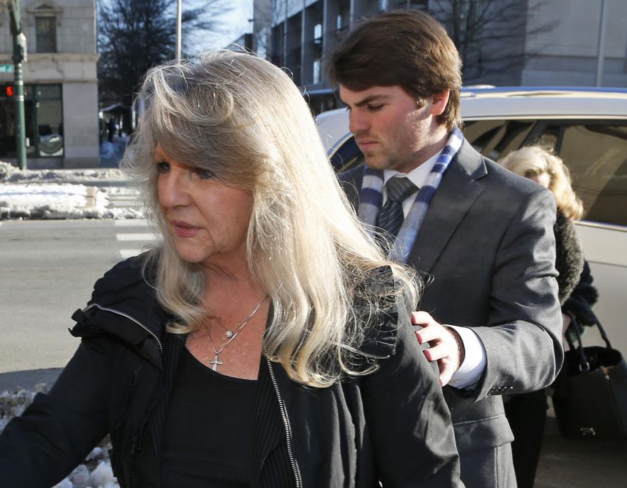 Former first lady Maureen McDonnell, left, arrives at federal court with her son Bobby for her sentencing on corruption charges in Richmond, Va., Friday, Feb. 20, 2015. Federal prosecutors have recommended an 18-month prison term, six months less than former Gov. Bob McDonnell received when he was convicted on 11 counts last month. (AP Photo/Steve Helber)