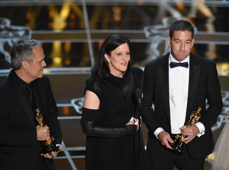Dirk Wilutzky, from left, Laura Poitras and Glenn Greenwald accept the award for best documentary feature for “Citizenfour” at the Oscars on Sunday, Feb. 22, 2015, at the Dolby Theatre in Los Angeles. (Photo by John Shearer/Invision/AP)