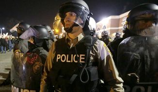 Events in Ferguson and New York have affected police morale. — FILE (AP Photo/Charlie Riedel, File)