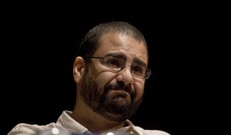 In this Monday, Sept. 22, 2014 photo, Egypt’s most prominent activist Alaa Abdel-Fattah takes a moment as he speaks about his late father Ahmed Seif, one of Egypt’s most respected human rights lawyers, during a conference held at the American University in Cairo, Egypt, near Tahrir Square. A court in Egypt has sentenced Abdel-Fattah, an icon of its 2011 revolt to five years in prison after a retrial on Monday, Feb. 23, 2015. (AP Photo/Nariman El-Mofty)