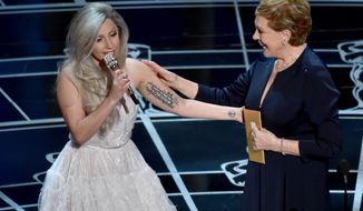 Lady Gaga, left, and Julie Andrews speak at the Oscars on Sunday, Feb. 22, 2015, at the Dolby Theatre in Los Angeles. (Photo by John Shearer/Invision/AP)