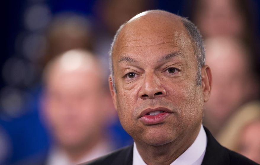 Homeland Security Secretary Jeh Johnson, joined by the department employees, during a news conference in Washington, Monday, Feb. 23, 2015. A partial shutdown of the Homeland Security Department loomed at week’s end, but no solution was in sight as senators returned to the Capitol from a week-long recess Monday to confront an impasse over the issue. (AP Photo/Manuel Balce Ceneta)