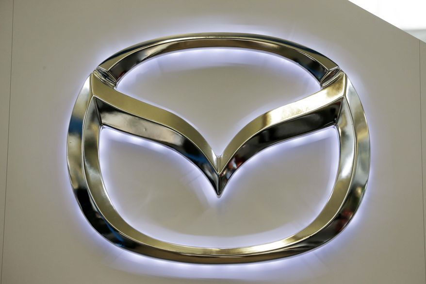 This Feb. 14, 2013, file photo shows the Mazda logo on a sign at the 2013 Pittsburgh Auto Show, in Pittsburgh. (AP Photo/Gene J. Puskar, File)