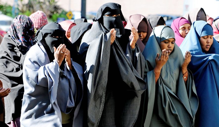 Women in traditional Muslim dress take part in prayers outside the federal courthouse before a jury found 35-year-old Amina Farah Ali and 64-year-old Hawo Mohamed Hassan guilty on all counts Thursday, Oct. 20, 2011, in Minneapolis of conspiring to funnel money to a terrorist group in Somalia. Prosecutors say the women, U.S. citizens of Somali descent, were part of a &quot;deadly pipeline&quot; that routed money and fighters from the U.S. to Somalia. (Associated Press)