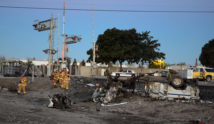 Firefighters arrive to attend to injured passengers at the scene of a Metrolink accident, Tuesday, Feb. 24, 2015, in Oxnard, Calif. Three cars of a Southern California Metrolink commuter train have derailed and tumbled onto their sides after a collision with a truck on tracks in Ventura County, northwest of Los Angeles. (AP Photo/Johnny Corona)