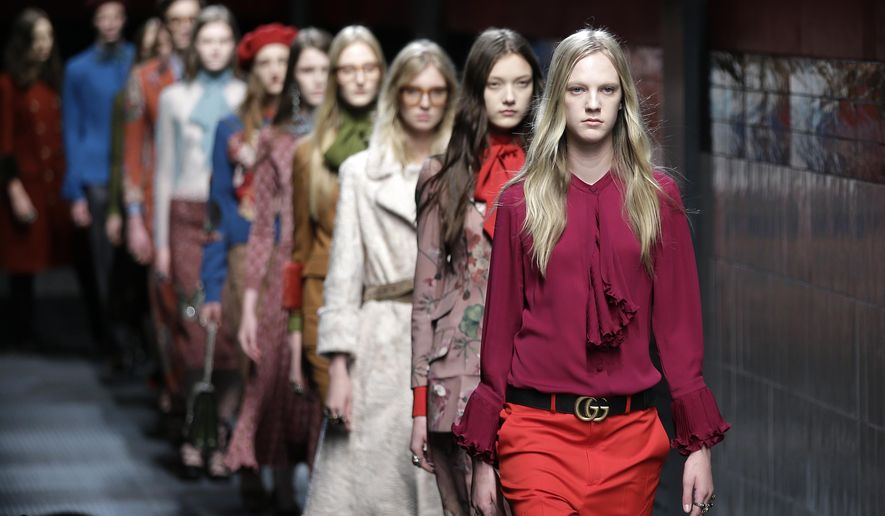 Models wear creations for Gucci women's Fall-Winter 2015-2016 collection, part of the Milan Fashion Week, unveiled in Milan, Italy, Wednesday, Feb. 25, 2015. (AP Photo/Antonio Calanni)