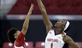 Maryland guard Laurin Mincy, right, reaches for a rebound over Indiana guard Larryn Brooks in the first half of an NCAA college basketball game, Thursday, Feb. 26, 2015, in College Park, Md. (AP Photo/Patrick Semansky)
