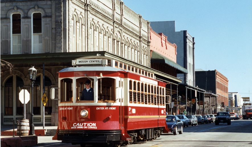 In this Jan. 10, 1990 photo, a Galveston Trolley goes down Strand Avenue near 22nd Street in Galveston, Texas. The island city&#39;s Trolley cars were destroyed during Hurricane Ike. On Thursday, Feb. 26, 2015, the City Council is taking a vote to use the old track cars or use gas powered wheeled trolley cars. (AP Photo/Houston Chronicle)