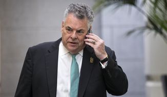 Rep. Peter King, R-N.Y., talks on his phone as he walks on Capitol Hill in Washington in this Sept. 26, 2013, file photo. (AP Photo/J. Scott Applewhite)
