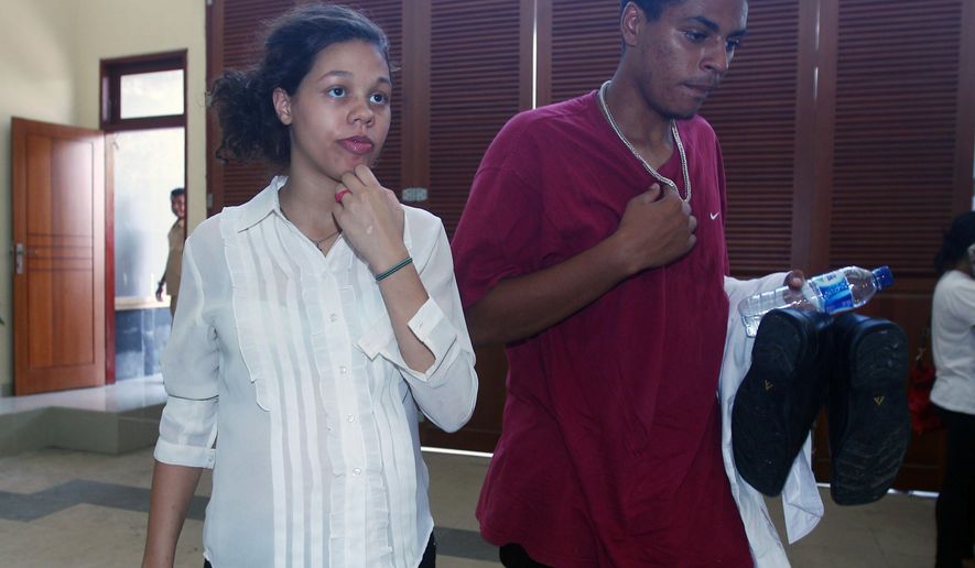 Heather Mack, left, and her boyfriend Tommy Schaefer, right, both from Chicago, Ill., walk into a prison after their trial at Denpasar District Court in Bali, Indonesia, on Thursday, Feb. 26, 2015. The couple is charged with murdering Mack's mother, Sheila von Wiese-Mack, whose badly beaten body was found in a suitcase outside of an upscale hotel last year. (AP Photo/Firdia Lisnawati)