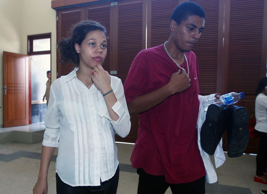 Heather Mack, left, and her boyfriend Tommy Schaefer, right, both from Chicago, Ill., walk into a prison after their trial at Denpasar District Court in Bali, Indonesia, on Thursday, Feb. 26, 2015. The couple is charged with murdering Mack's mother, Sheila von Wiese-Mack, whose badly beaten body was found in a suitcase outside of an upscale hotel last year. (AP Photo/Firdia Lisnawati)
