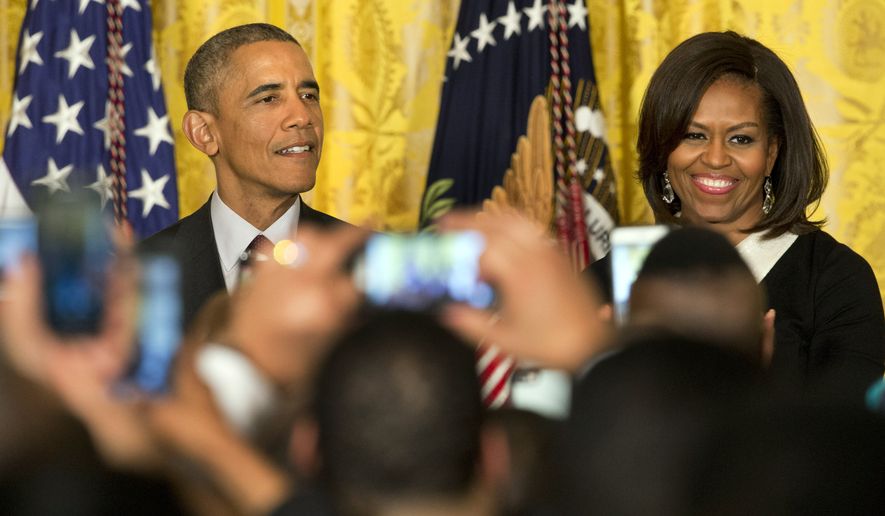 President Barack Obama, left, speaks next to first lady Michelle Obama during a reception in recognition of African American History Month in the East Room of the White House Washington, Thursday, Feb. 26, 2015. (AP Photo/Jacquelyn Martin)