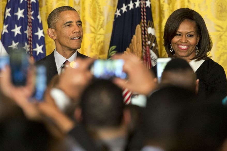 President Barack Obama, left, speaks next to first lady Michelle Obama during a reception in recognition of African American History Month in the East Room of the White House Washington, Thursday, Feb. 26, 2015. (AP Photo/Jacquelyn Martin)