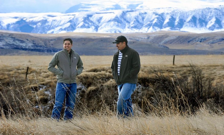 In this photo taken on Feb. 17, 2015, Clayvin Herrera, right, a game warden for the Crow Tribe, and felow tribe member Ronnie Fisher, are shown on the Crow Reservation in northern Wyoming. Last year, Herrera, Fisher and another tribal member were charged by a Wyoming Game and Fish Department warden for killing three bull elk without licenses. Now Herrera finds himself embroiled in a 147-year-old treaty rights quarrel. (AP Photo/The Billings Gazette, James Woodcock)