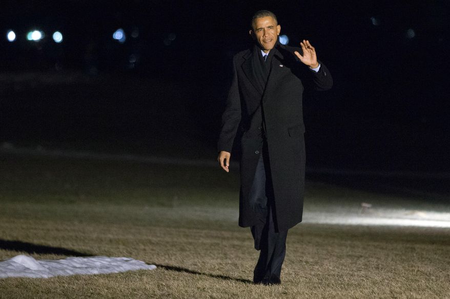 President Barack Obama waves as walks across the South Lawn of the White House after speaking about immigration in Miami, on his return in Washington, Wednesday, Feb. 25, 2015, (AP Photo/Jacquelyn Martin)