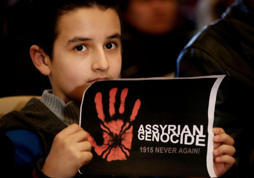 An Assyrian boy holds a poster during a sit-in for abducted Christians in Syria and Iraq, at a church in Sabtiyesh area east Beirut, Lebanon, Thursday, Feb. 26, 2015. Islamic State militants snatched more hostages from homes in northeastern Syria over the past three days, bringing the total number of Christians abducted to over 220 in the one the largest hostage-takings by the extremist group, activists said Thursday. (AP Photo/Hussein Malla)